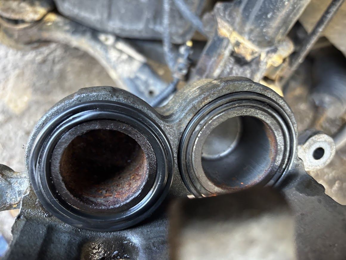 Mechanic inspecting worn brake pads and brake rotor during a mobile brake repair service in Sullivan County, NY