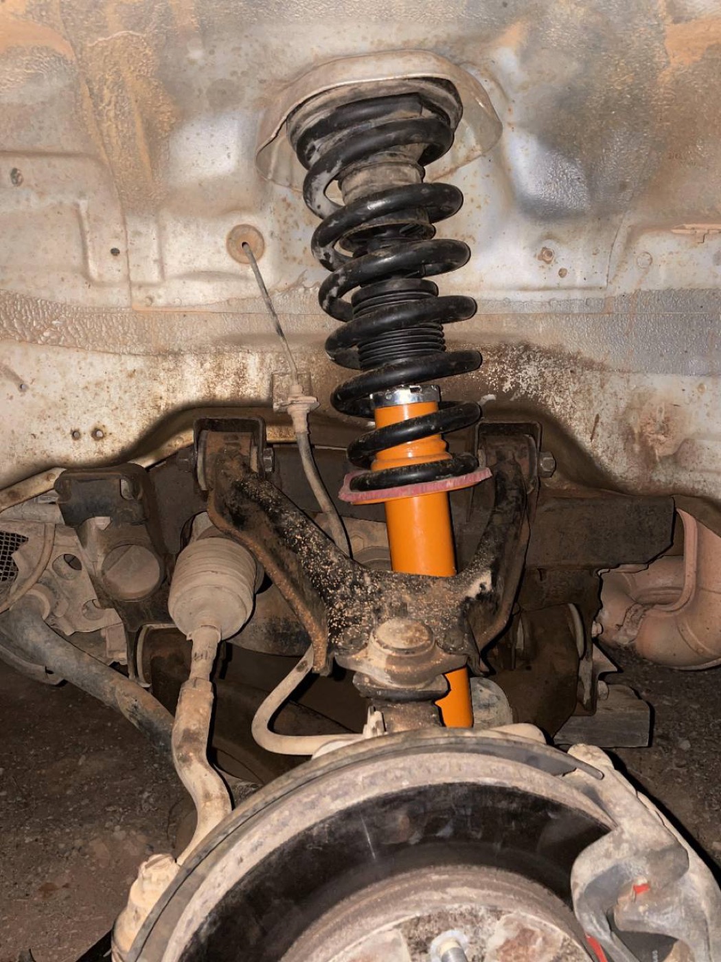 Installed strut and spring assembly during suspension work